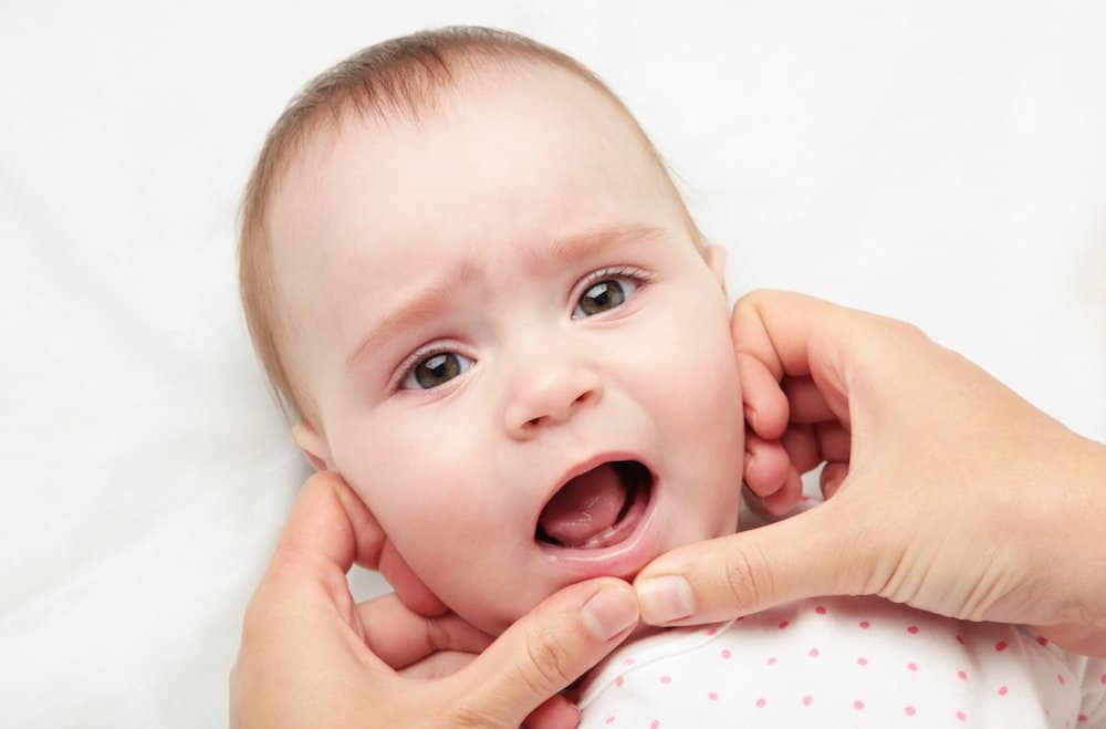 Baby's first tooth coming in
