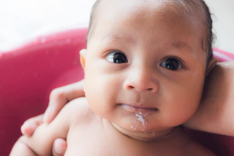 A 3-month baby just spit up some milk.