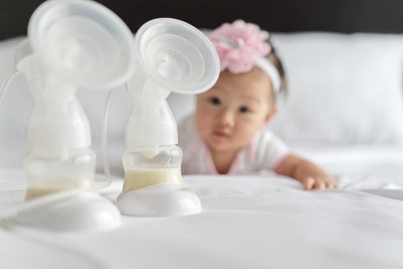 A mom is choosing to use a breast pump to get milk to feed her infant girl.