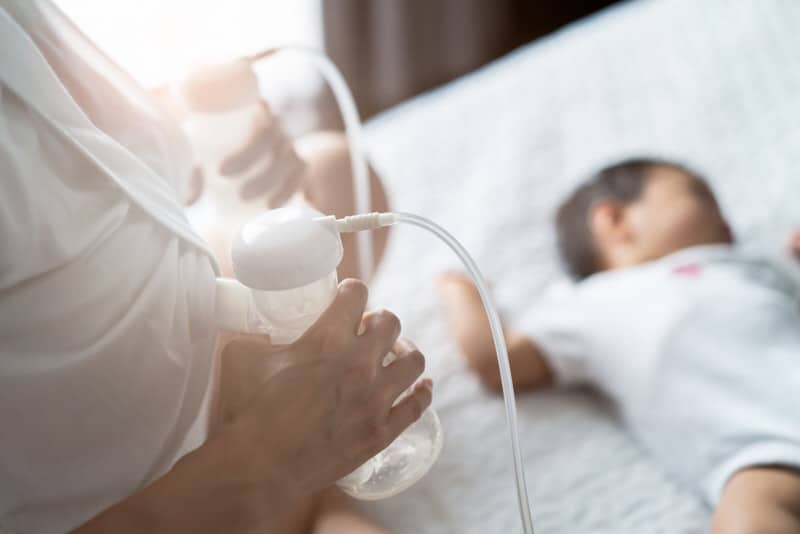 A new mom is transitioning from breastfeeding to pumping to feed her newborn baby.