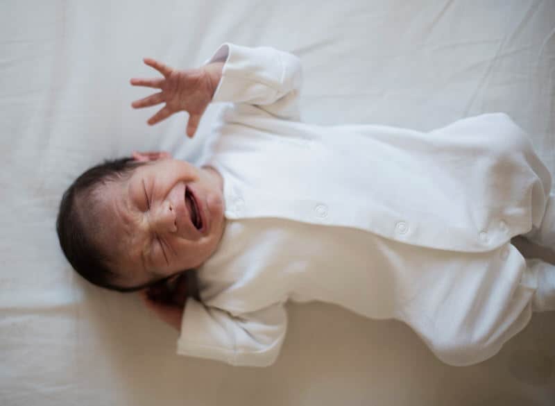 An infant baby is crying and having a breath-holding spell, as a result of crying for too long and not being able to breathe.