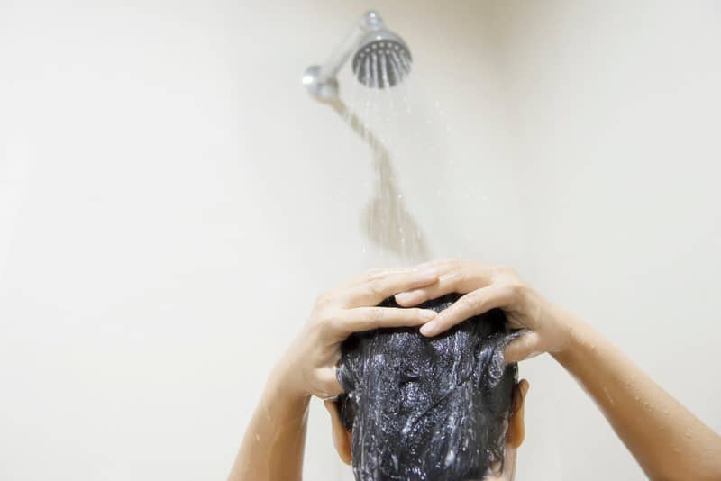 A new mom is having greasy hair after birth of her baby, so she's using a mild shampoo to help manage the greasy scalp.