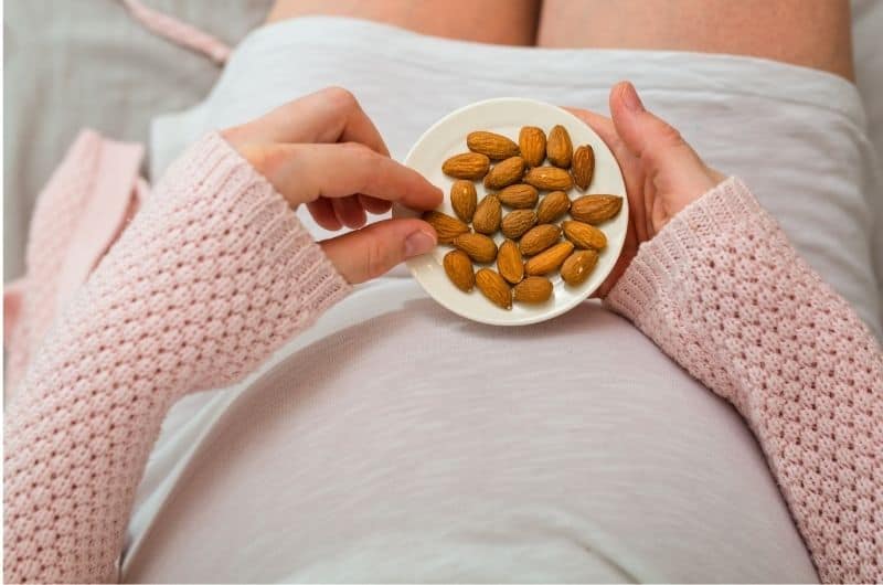 Mom is eating almonds after pregnancy, to help get nutrients when she barely has an appetite.
