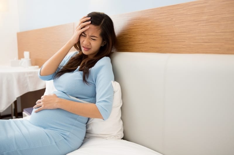 A pregnant woman is feeling nausea, even more so after having smelled rubbing alcohol recently.