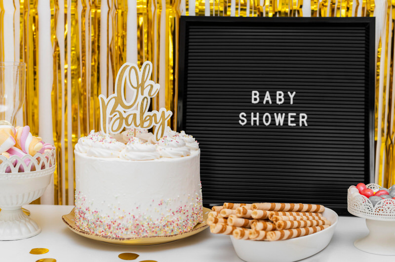 Baby shower cake with a topper saying "oh baby."
