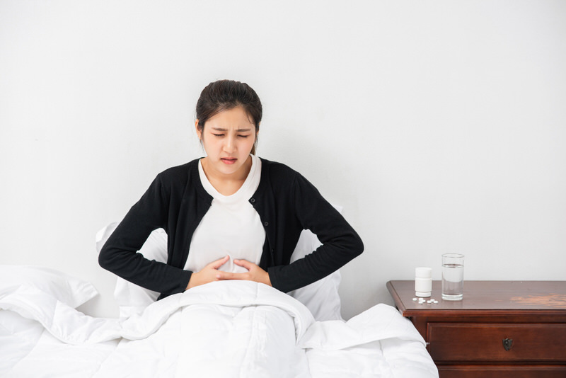 A pregnant woman is having morning sickness and is in bed trying to rest