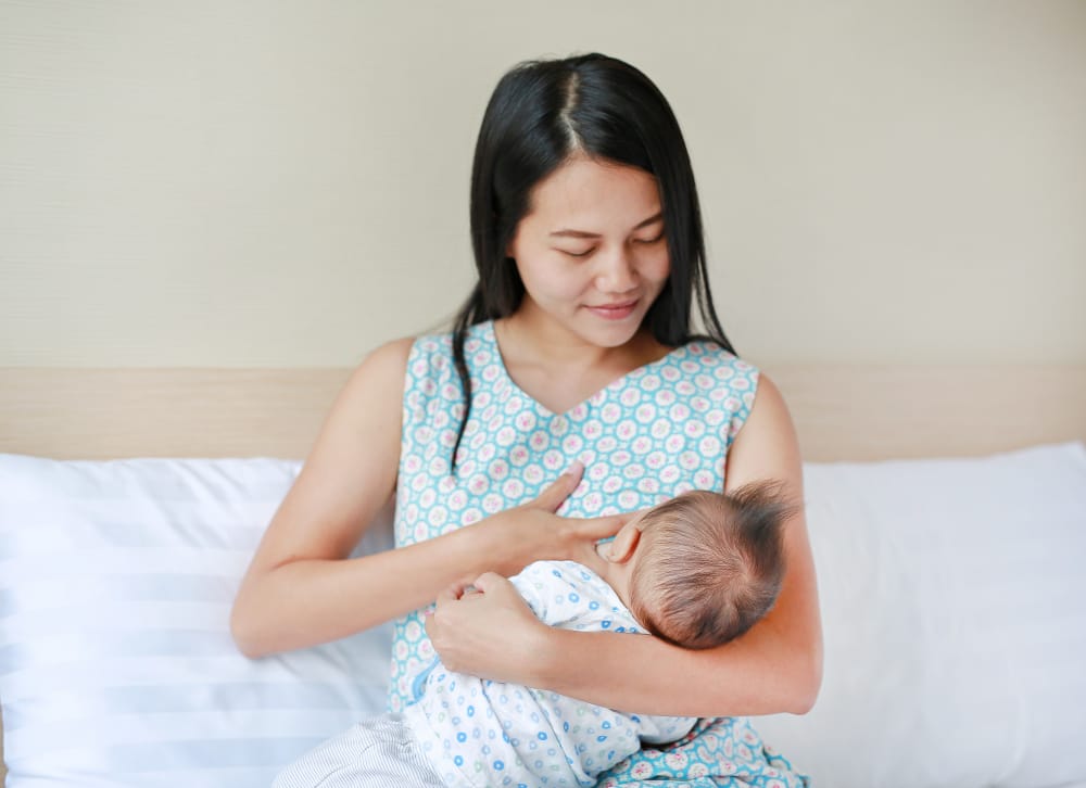 A mom is making sure to nurse her newborn frequently to increase her breastmilk production