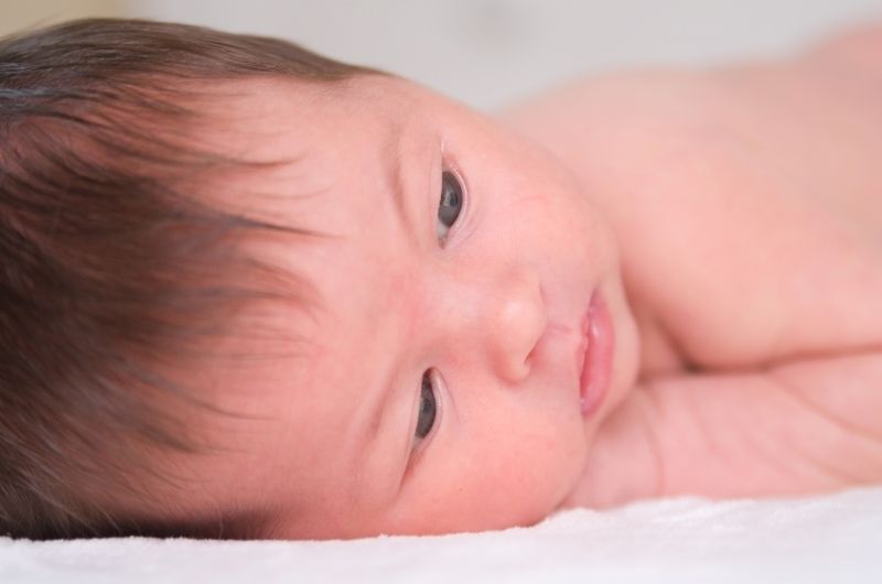 A newborn boy's eyebrows are faint yet getting more distinct as he grows and changes daily