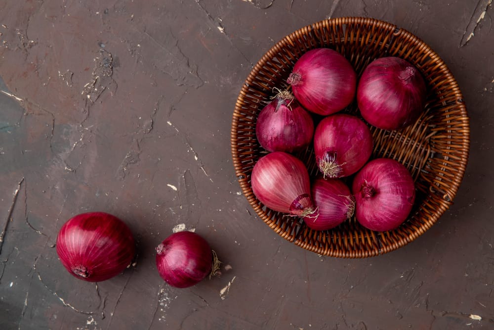 A batch of red onions in a basket