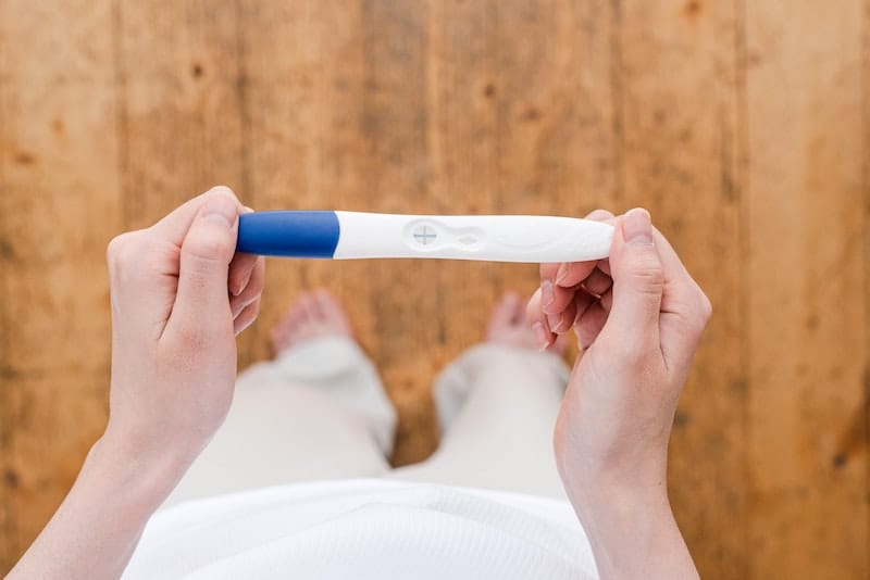 A young woman just did an at-home pregnancy test and is waiting for the results
