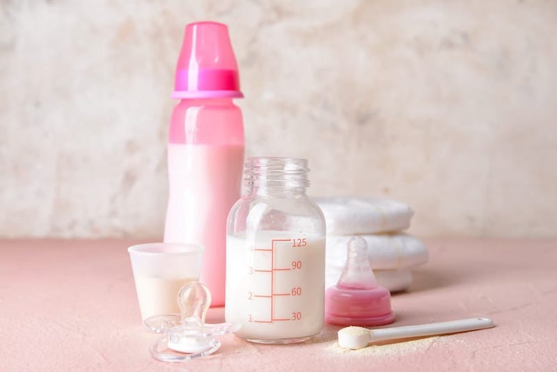A baby bottle with prepared formula milk in it