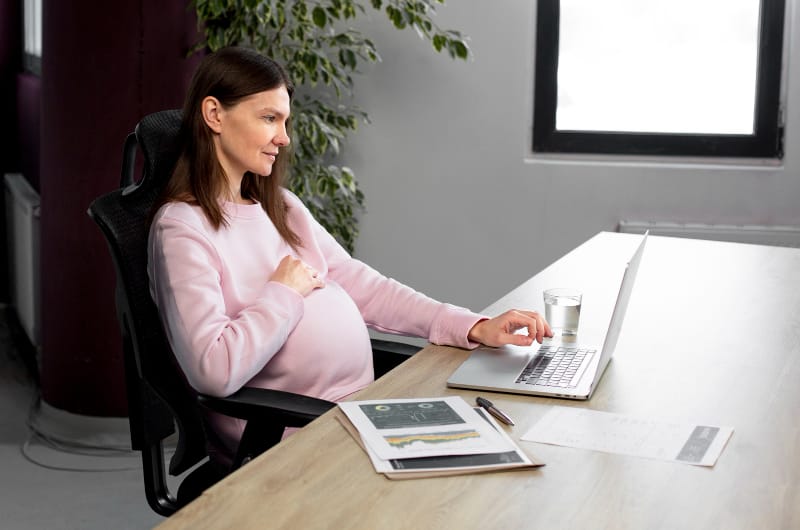 A woman in her third trimester is meeting with her Doctor via webcam to check up on the status of her UTI