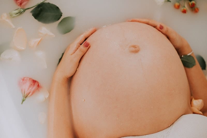 A pregnant woman is having a milk bath