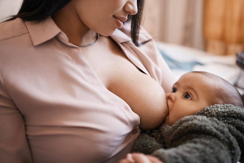 Mom is breastfeeding her infant daughter
