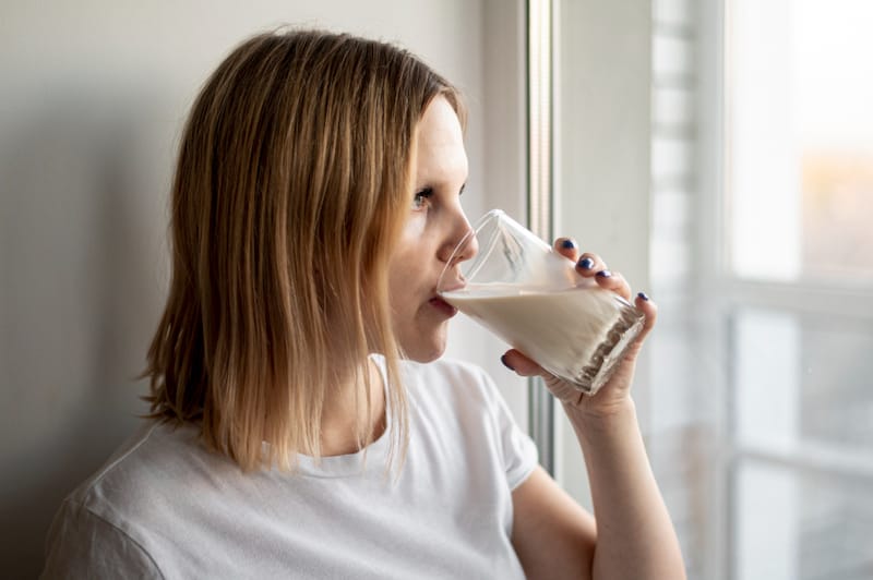 A pregnant woman is having a protein shake to help get to her daily protein intake