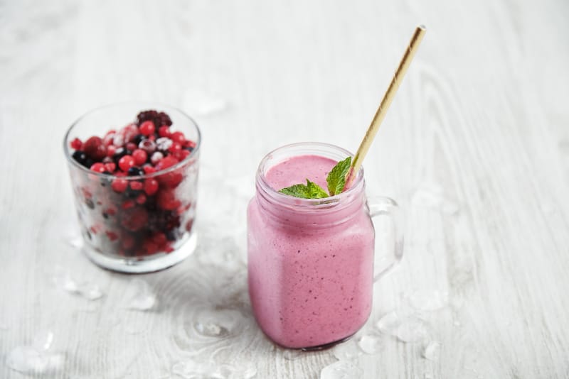 A glass of mixed berries smoothie is shown as an alternative to meal replacement protein shakes