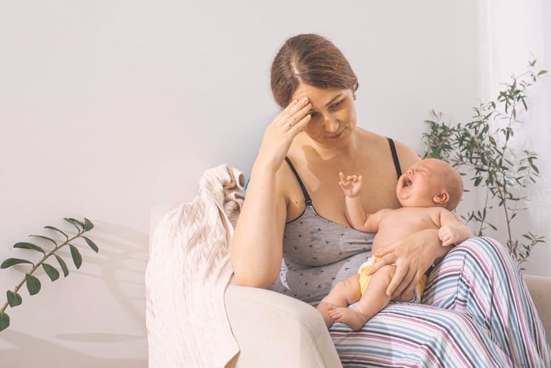A new mom is trying to breastfeed her newborn son, but is having a hard time due to a shallow latch.