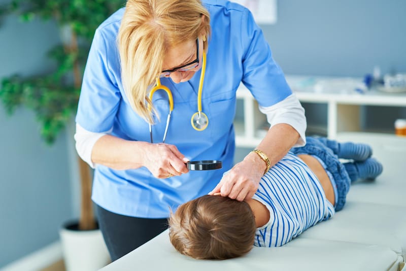 A pediatrician is examining the ears of her toddler patient, who seems to be excessively vomiting lately. She wants to check if he has an ear infection.