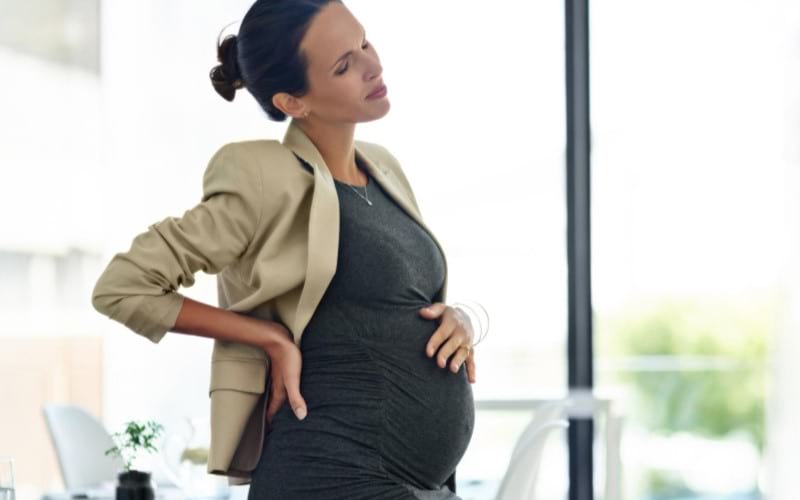 A pregnant woman in her third trimester is feeling premature contractions in her workplace.
