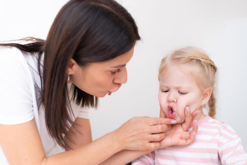 Mom noticed her toddler daughter putting something in her mouth, and is checking to see if it was something harmful