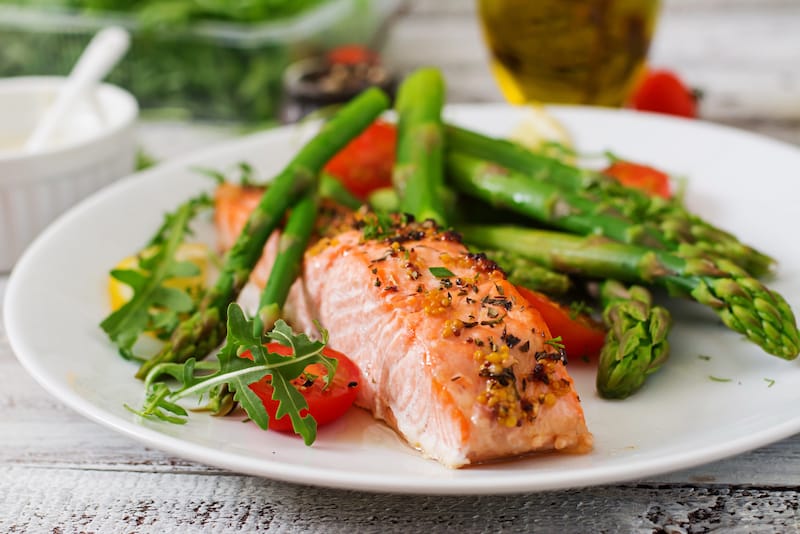 A plate of salmon is shown, a healthy food item for breastfeeding moms