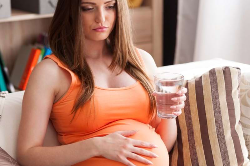 A pregnant woman is facing trouble with a big belly.